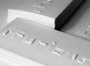 stack of white business cards with embossed logo