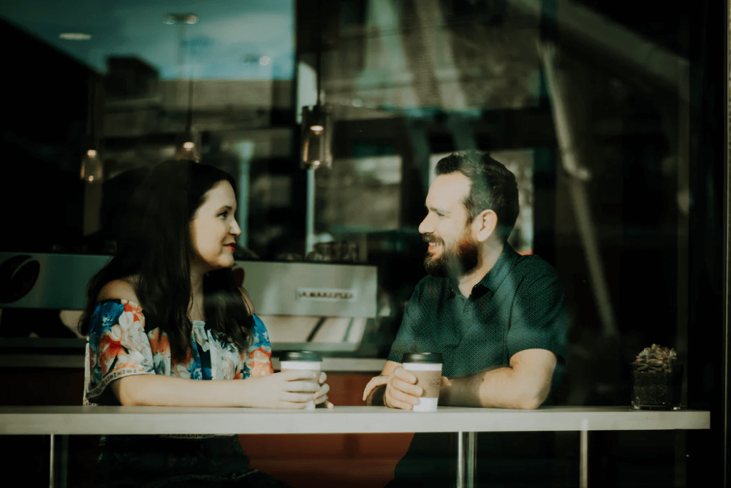 man and woman having coffee building workplace relationships