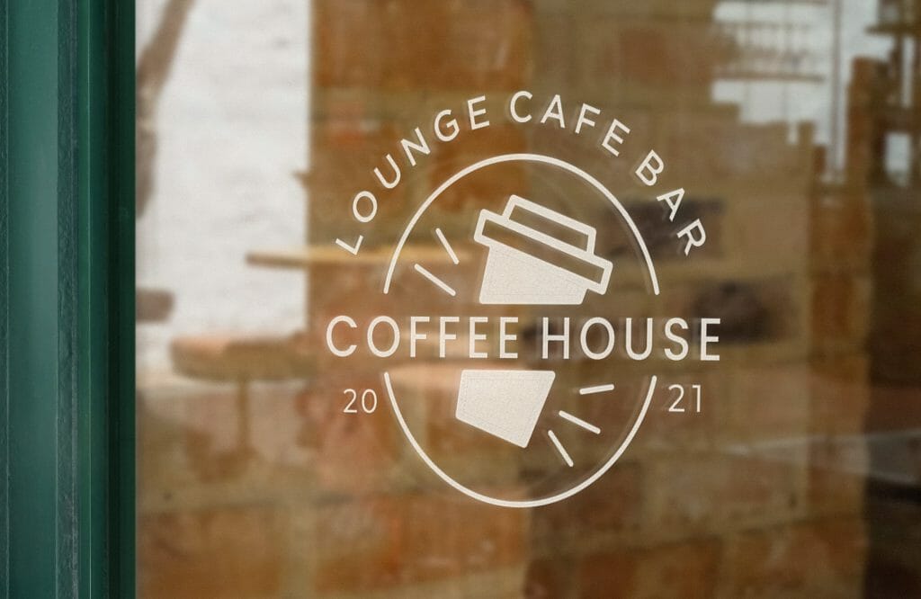 Image of a business sign in a window showing a takeaway coffee cup with the words coffee house written on it
